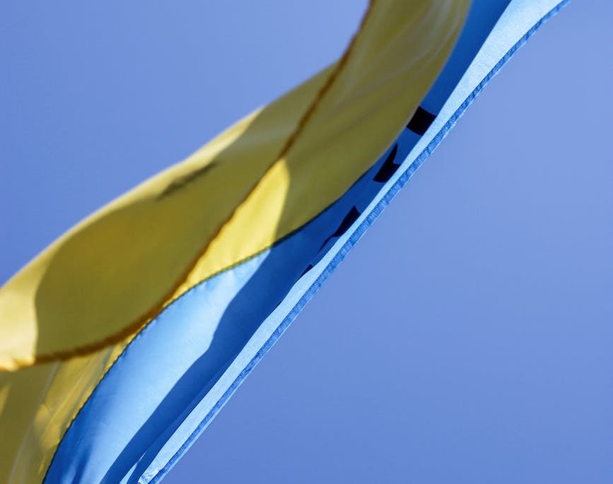 ukrainian flag waving in wind with clear sky in background