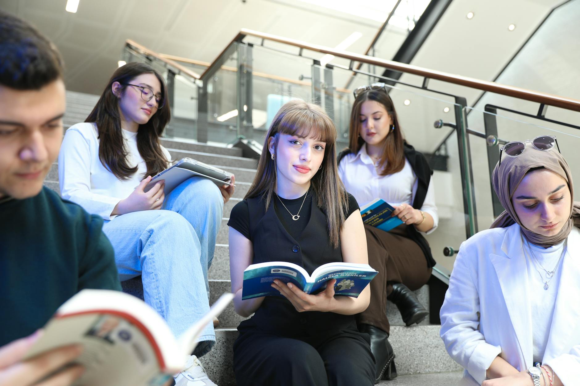university students studying on staircase